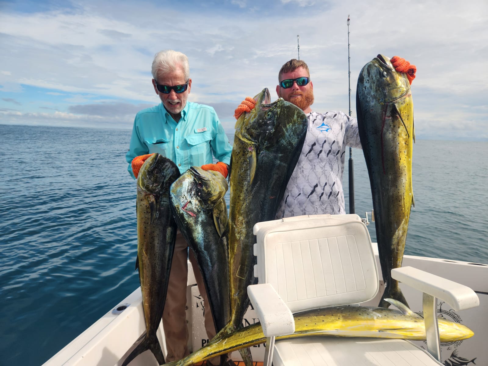 Two anglers with four mahi-mahi