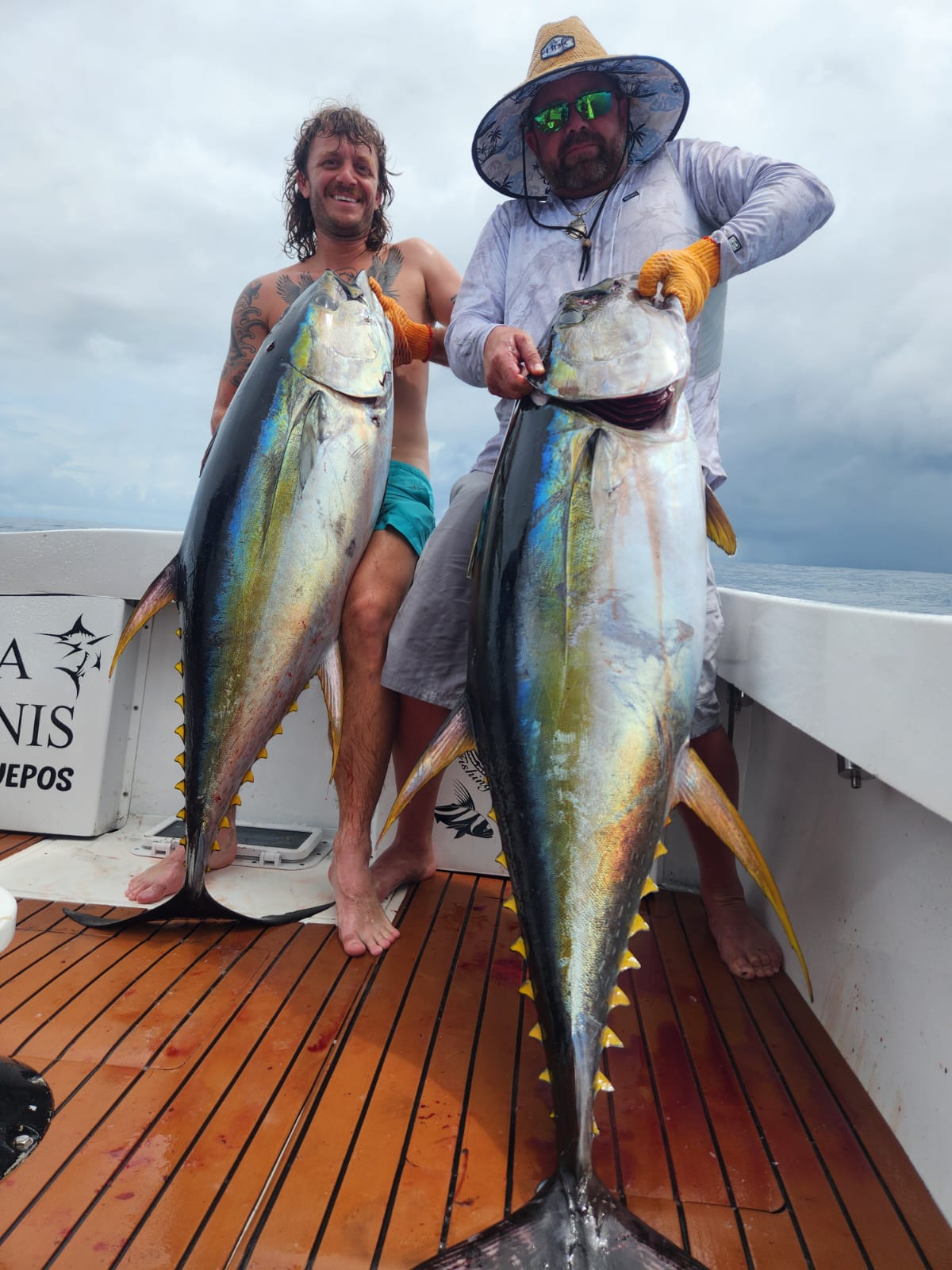 Angler with tuna on blue ocean