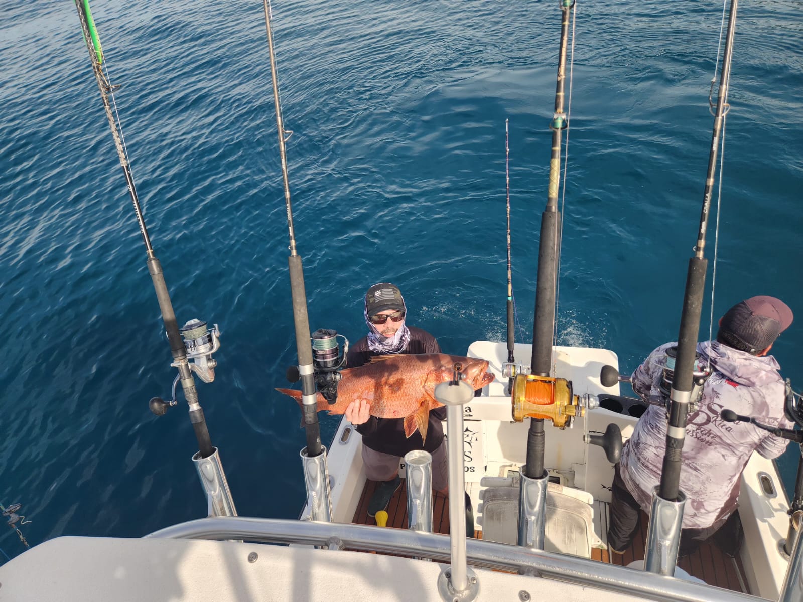 Two anglers landing a big cubera snapper